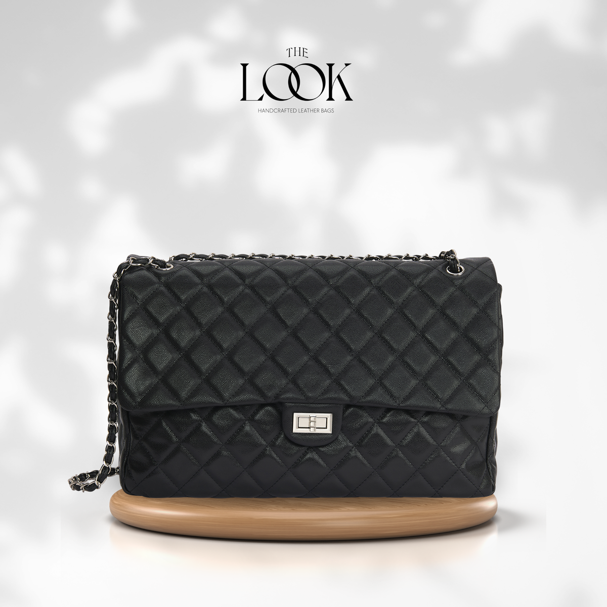 Black The Quilte Jumbo Convertible Travel Bag with silver hardware, front view | The Look Officiel
