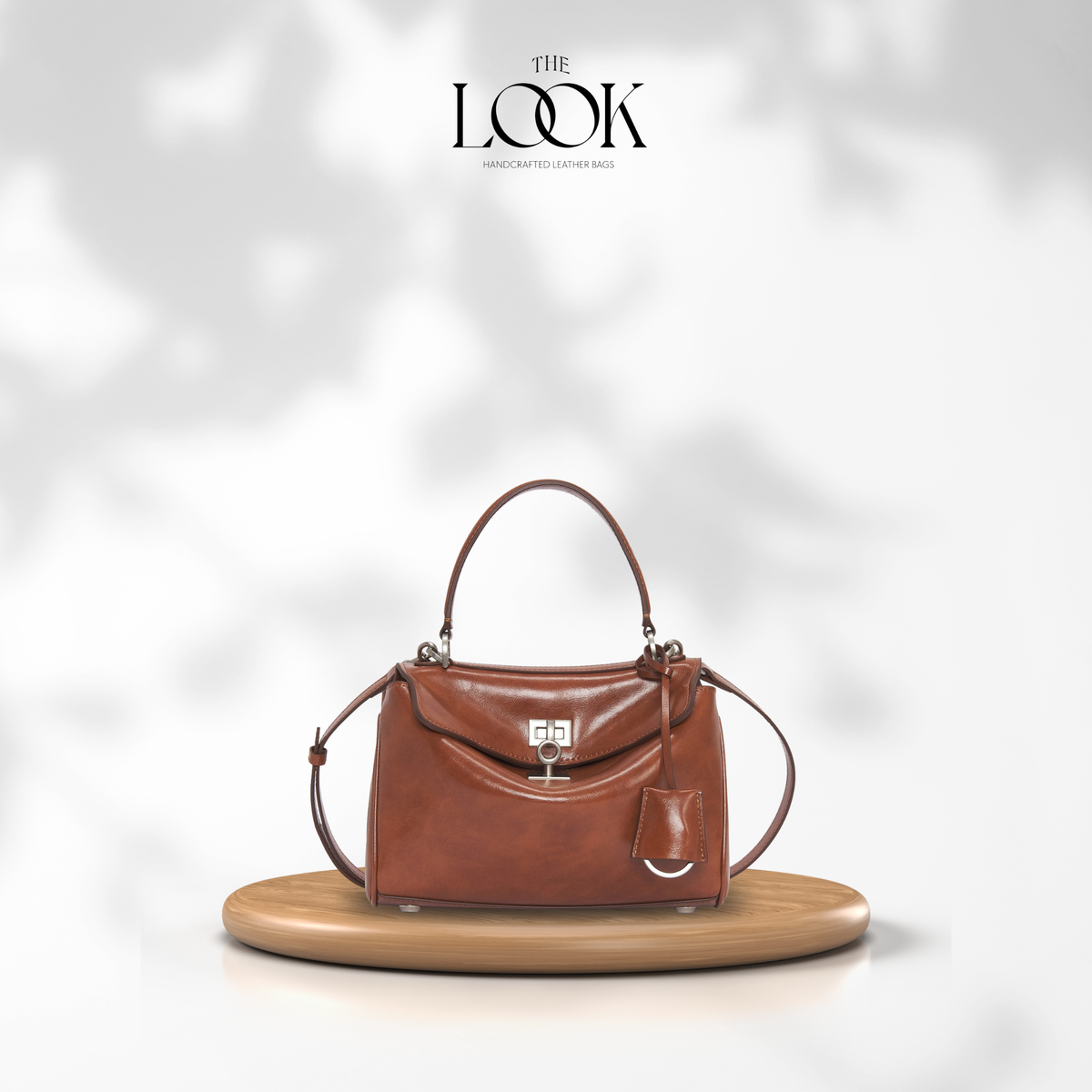 Valen Small Satchel in Caramel, front product view on wooden platform | The Look Officiel
