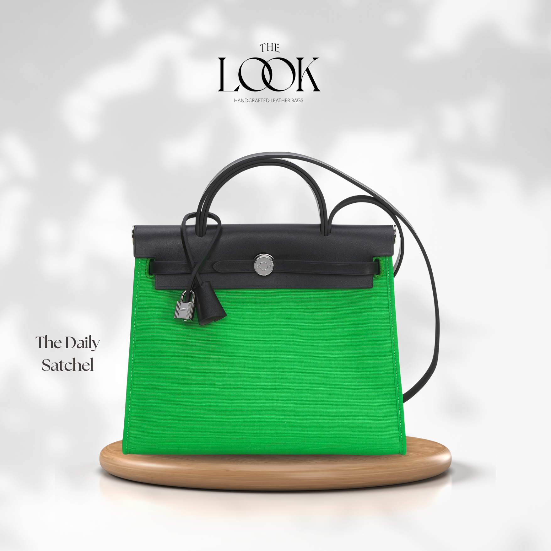 Green and black handbag on a wooden stand with 'The Look' branding. | The Look Officiel