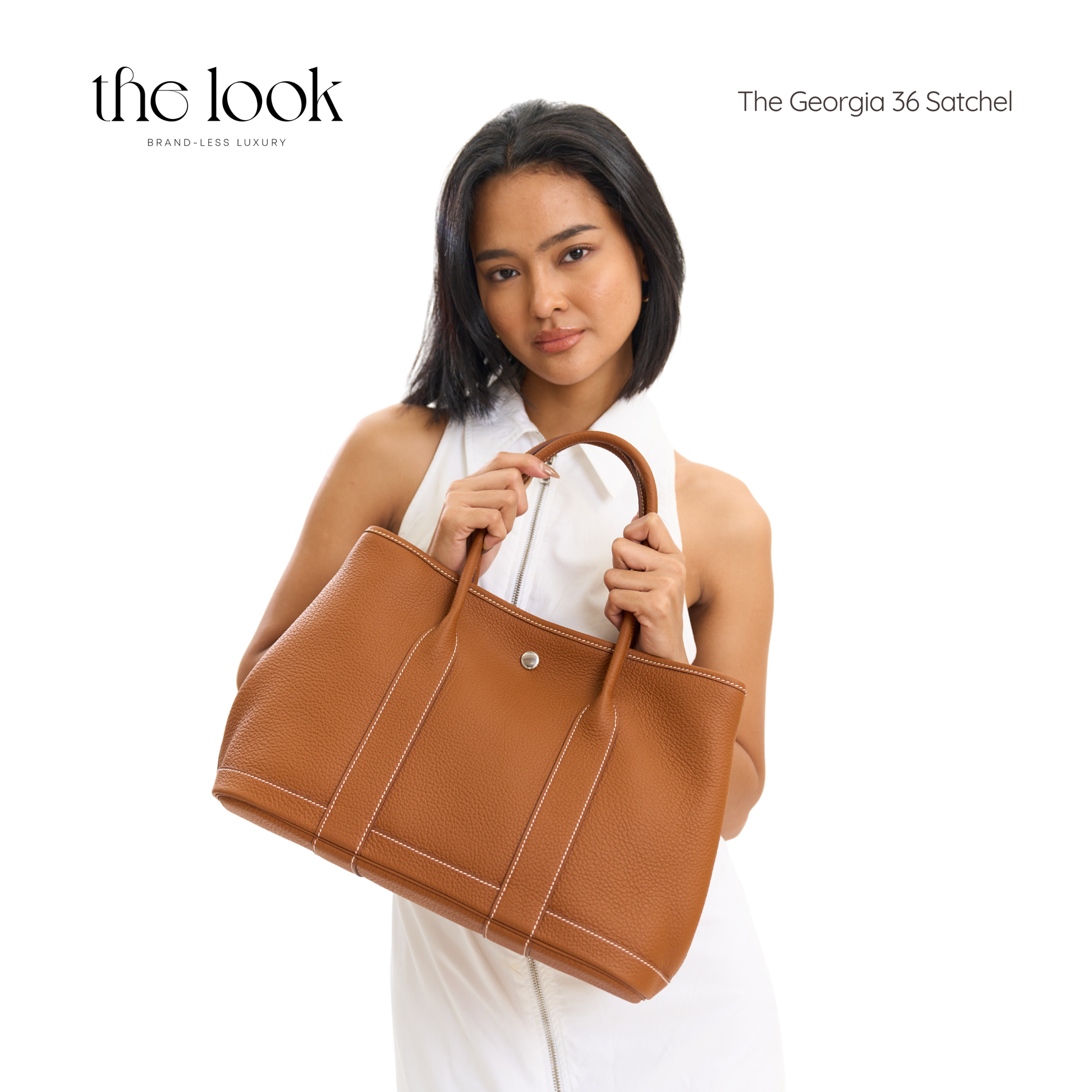 Woman holding a brown leather satchel with 'the look' branding on a white background | The Look Officiel