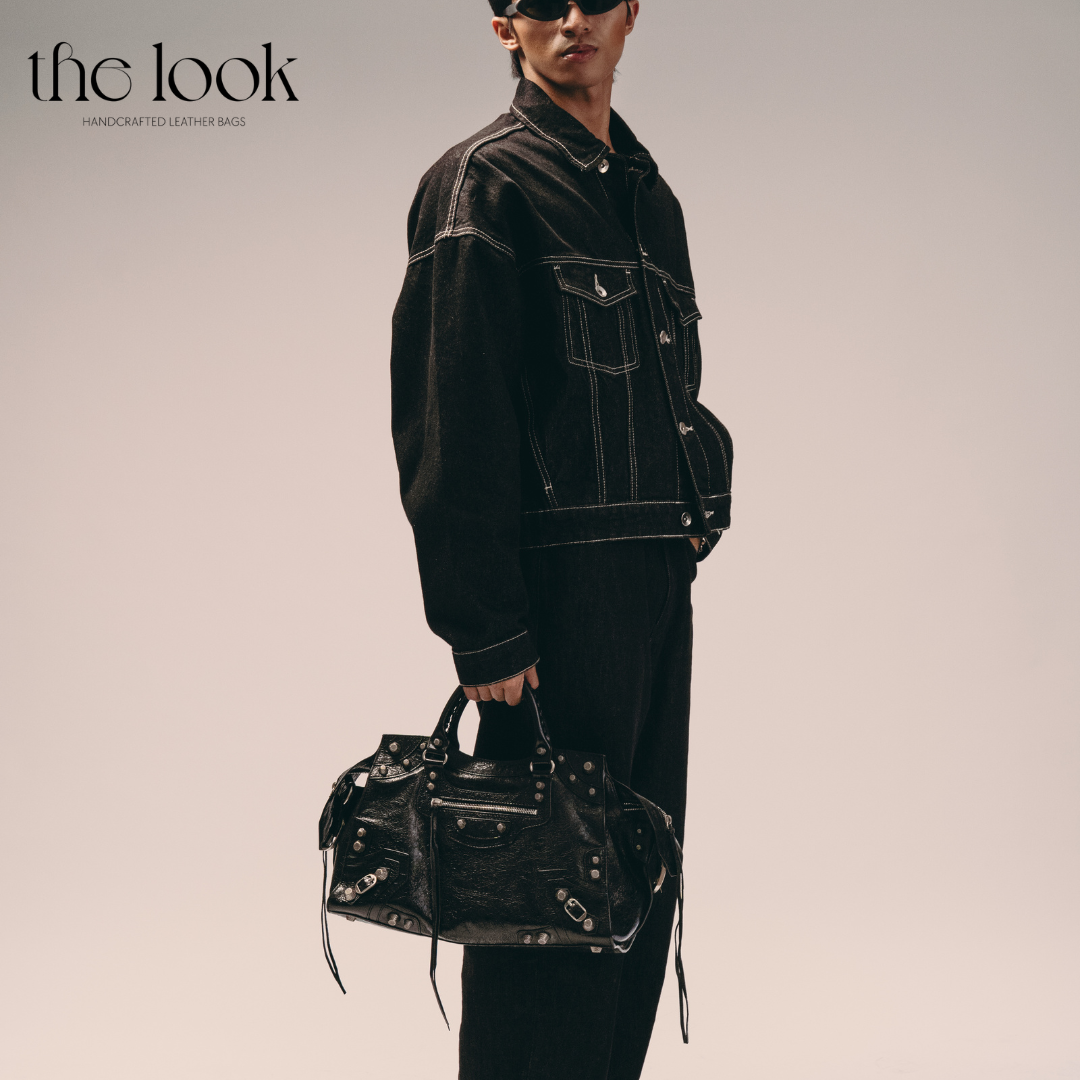 Model holding Biker Satchel Regular black goatskin braided handles gunmetal hardware front view