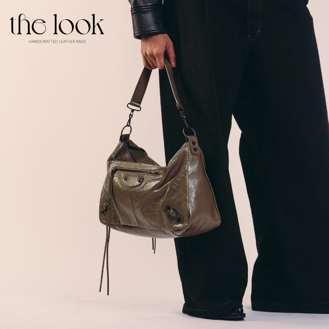 model holding Biker Convertible shoulder bag olive goatskin handle angled view