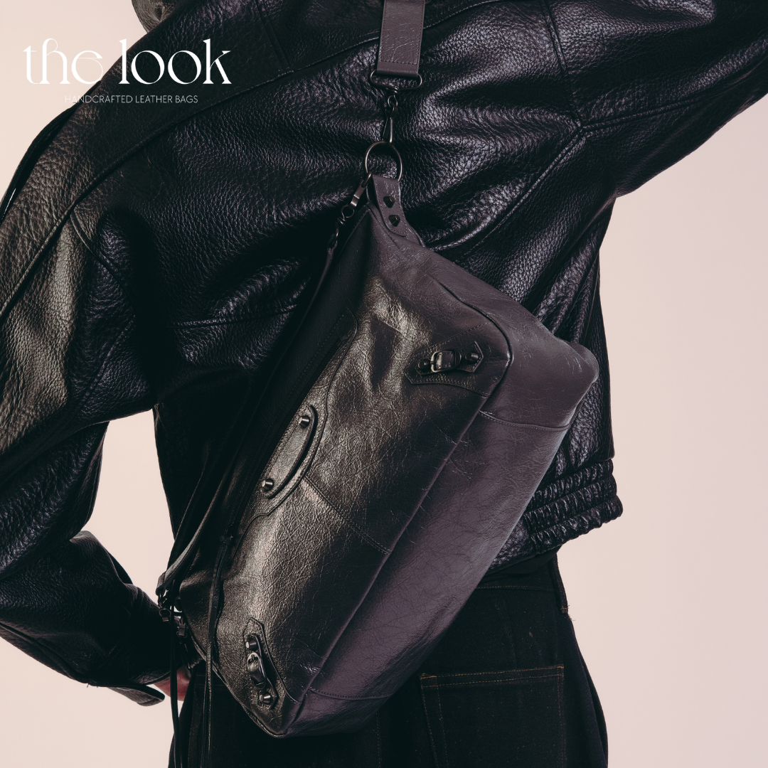 model wearing Biker Convertible shoulder bag black goatskin handle angled view