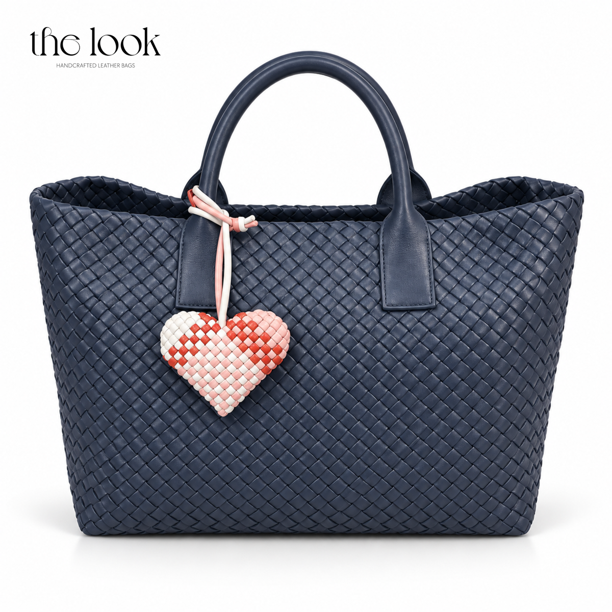 The Loop Amour woven leather heart bag charm in Strawberry Swirl on a navy woven tote