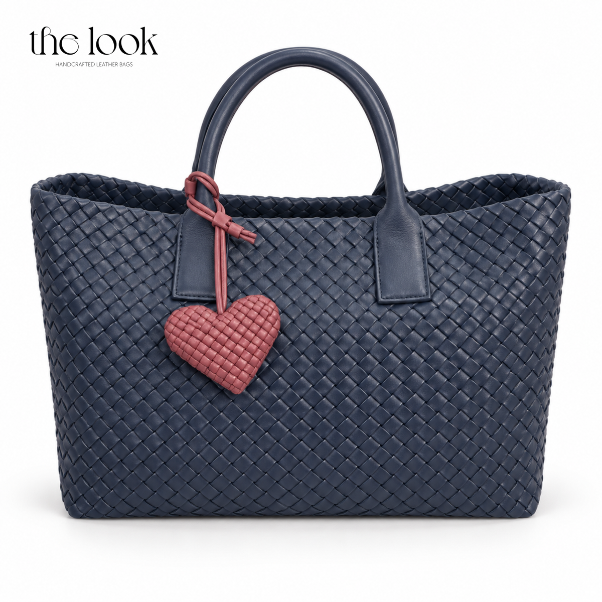 The Loop Amour woven leather heart bag charm in Berry on a navy woven tote