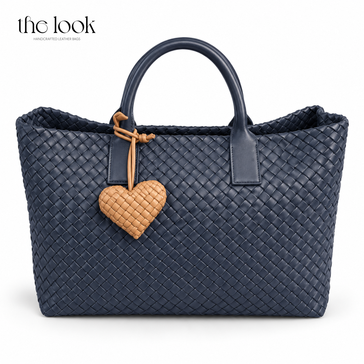 The Loop Amour Bag Charm woven leather heart bag charm in Honey Toffee on a navy woven tote