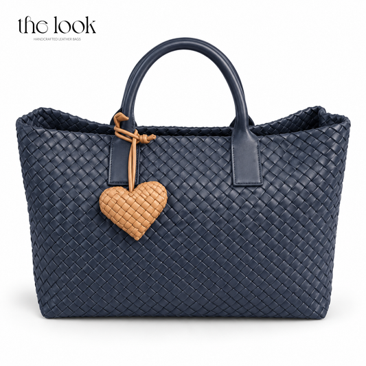 The Loop Amour Bag Charm woven leather heart bag charm in Honey Toffee on a navy woven tote