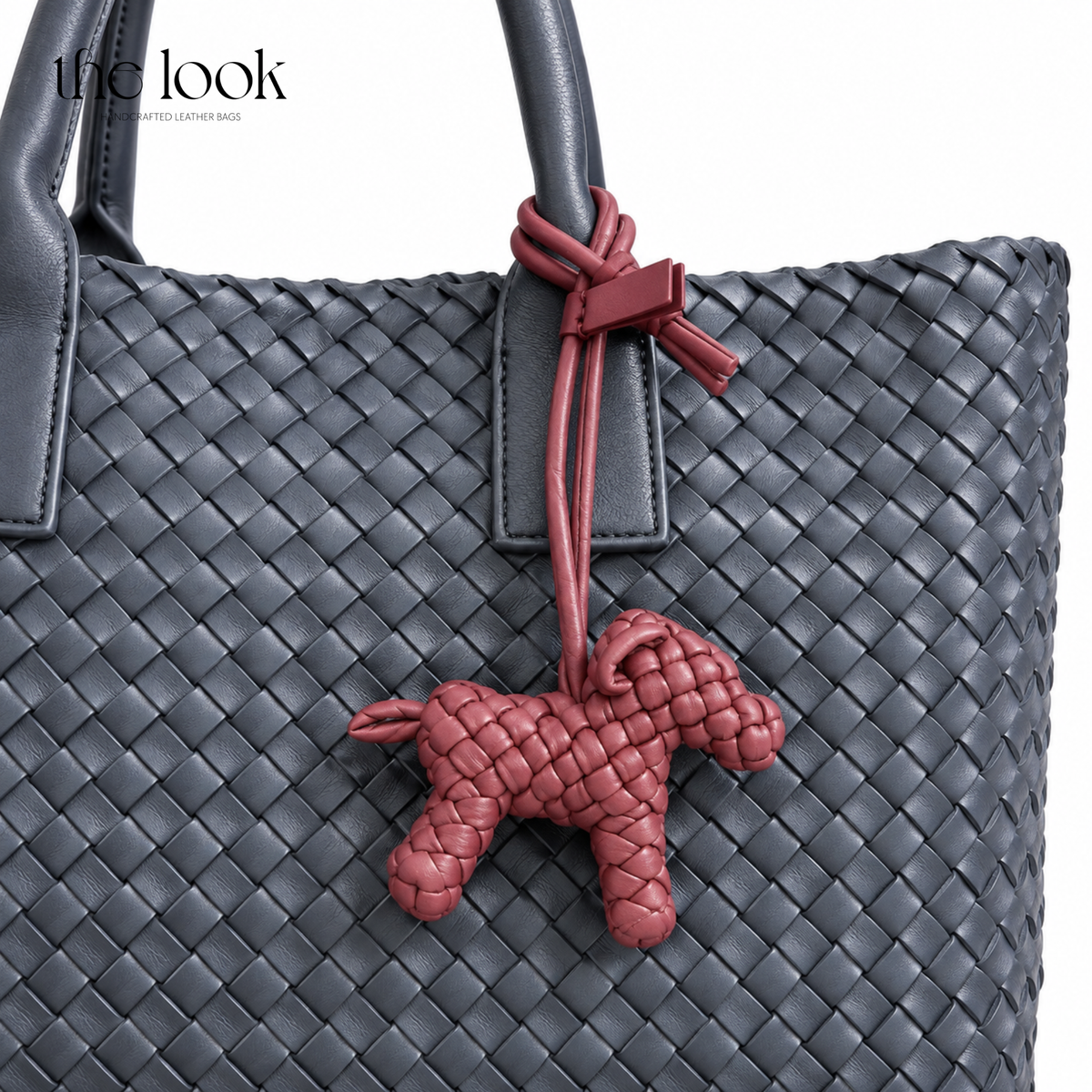 The Loop Pupper Bag Charm in Burgundy styled on a dark woven tote
