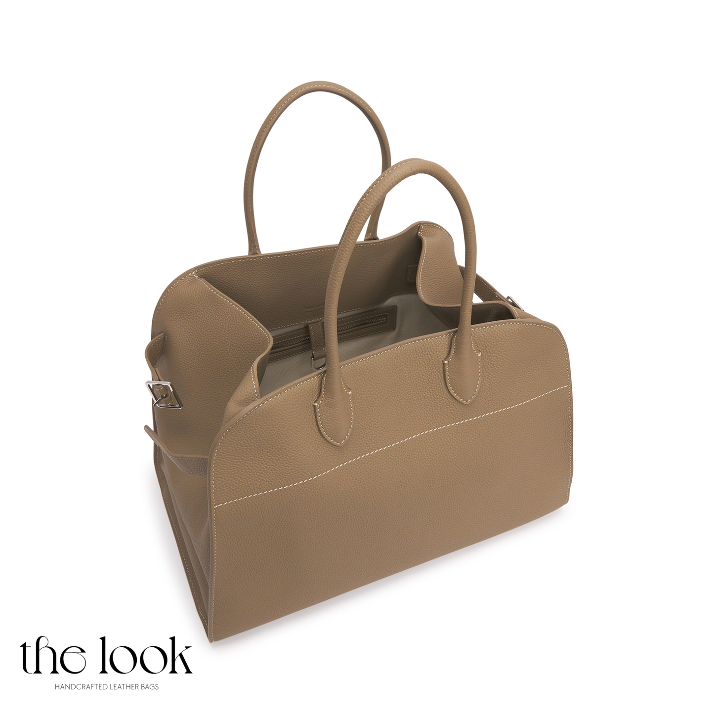 Brown leather bag with handles on a white background, branded 'the look'. | The Look Officiel