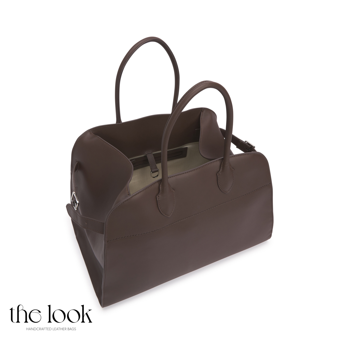 Brown leather handbag on a white background with 'the look' branding. | The Look Officiel