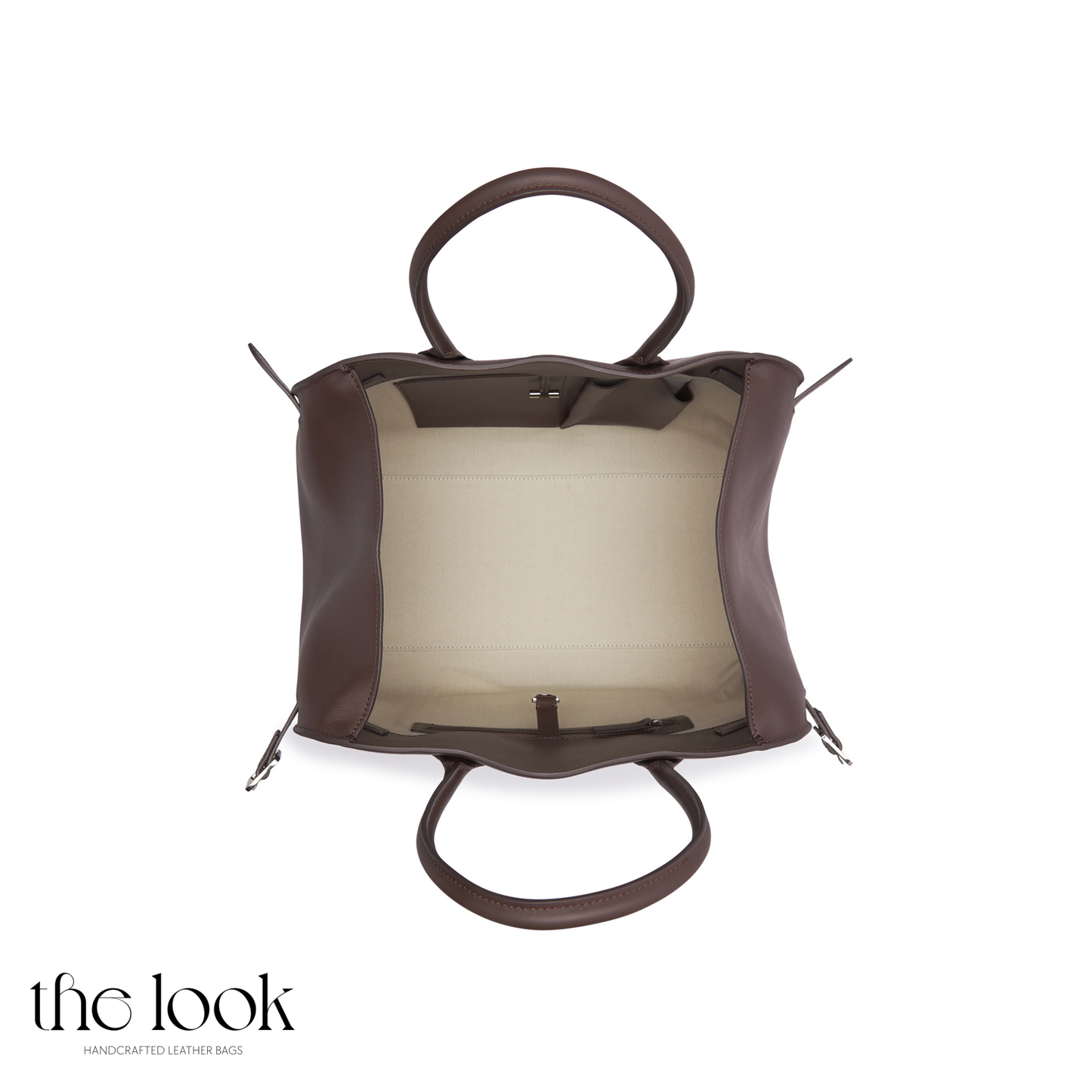 Brown leather handbag with a sheer panel on a white background, featuring 'the look' brand. | The Look Officiel