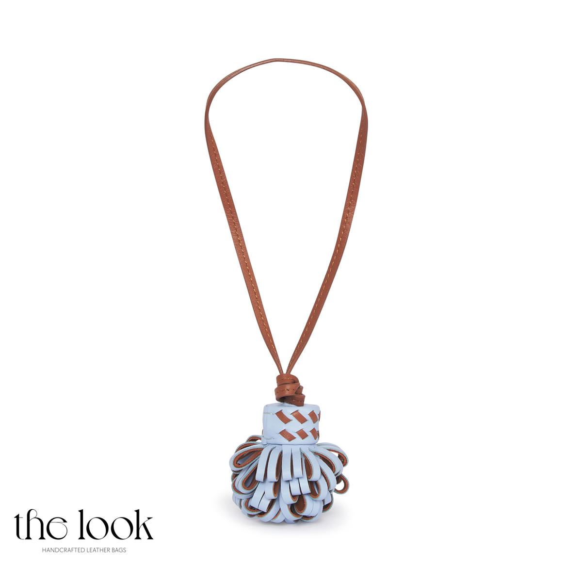 Pompette Cornflower Blue top-grain leather bag charm with pale blue loops, brown accents, and a stitched hanging loop | The Look Officiel