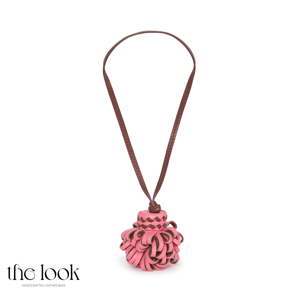 Pompette Coral Pink leather bag charm with layered pink and dark brown loops and a brown leather hanging loop | The Look Officiel