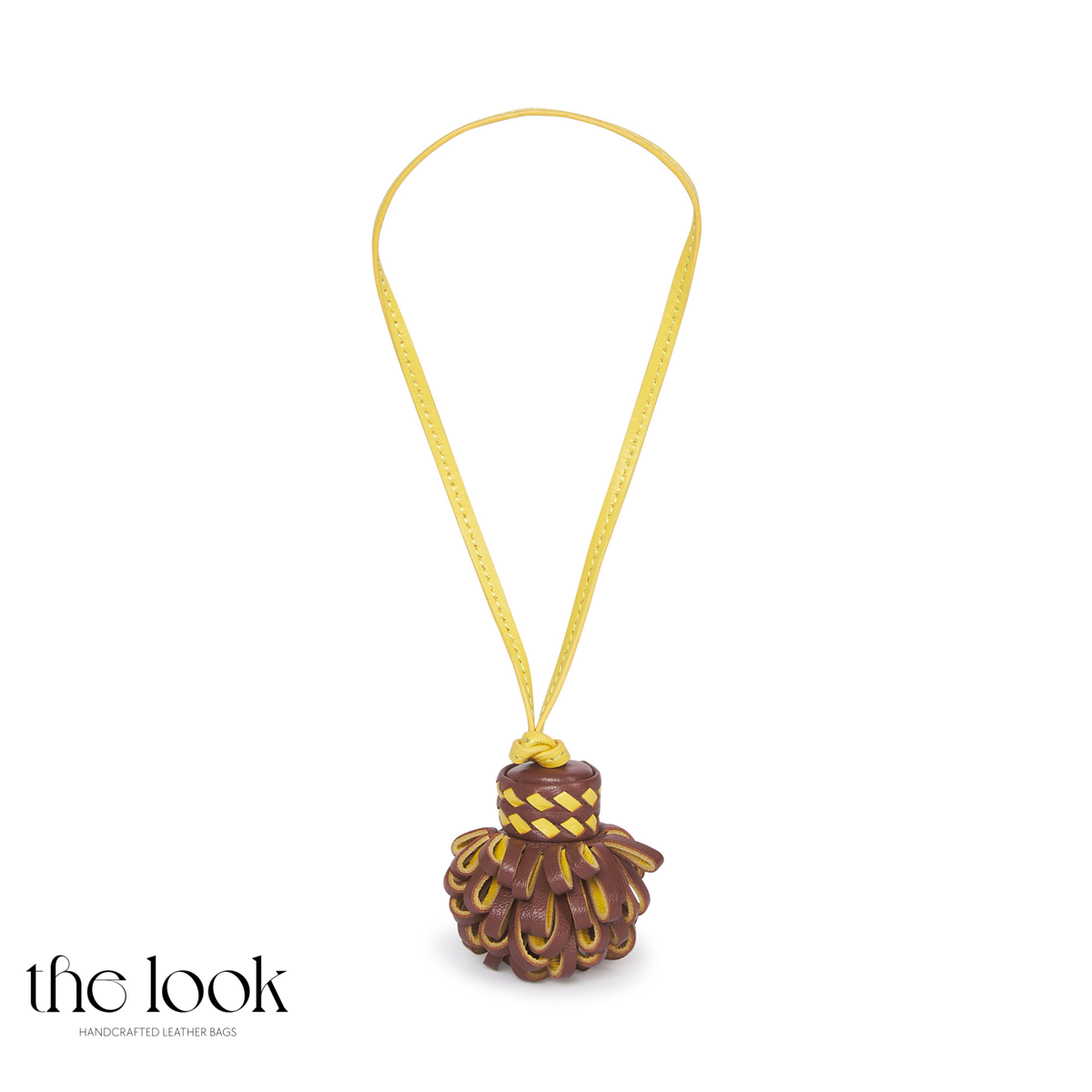 Pompette Chocolate Brown leather bag charm with yellow accents, woven-look detailing, and a yellow hanging loop | The Look Officiel
