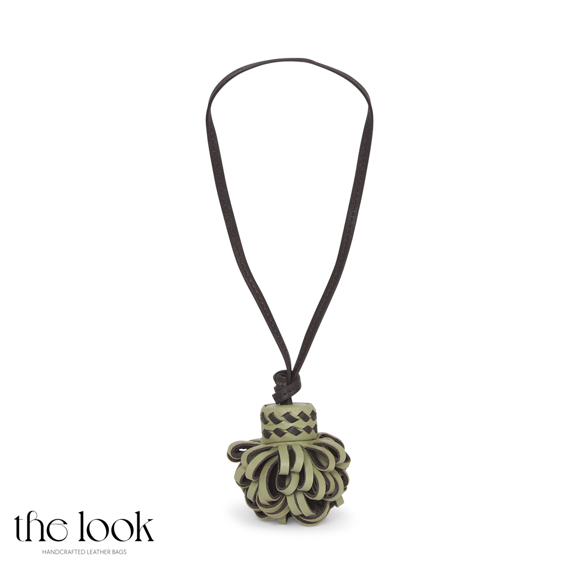 Pompette Sage Green leather bag charm with dark brown accents, layered loops, and a dark brown hanging loop | The Look Officiel