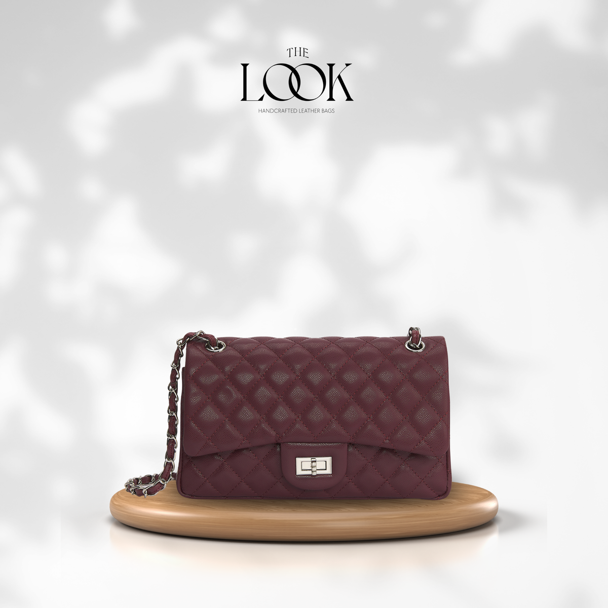 The Quilte Medium Convertible Shoulder Bag in burgundy caviar calfskin leather with silver hardware, front view | The Look Officiel