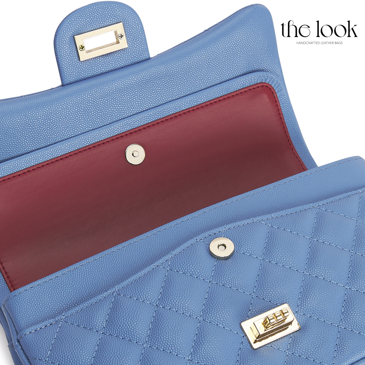 The Quilte Medium Convertible Shoulder Bag in cornflower blue caviar calfskin leather with silver hardware, double-flap interior close-up view | The Look Officiel