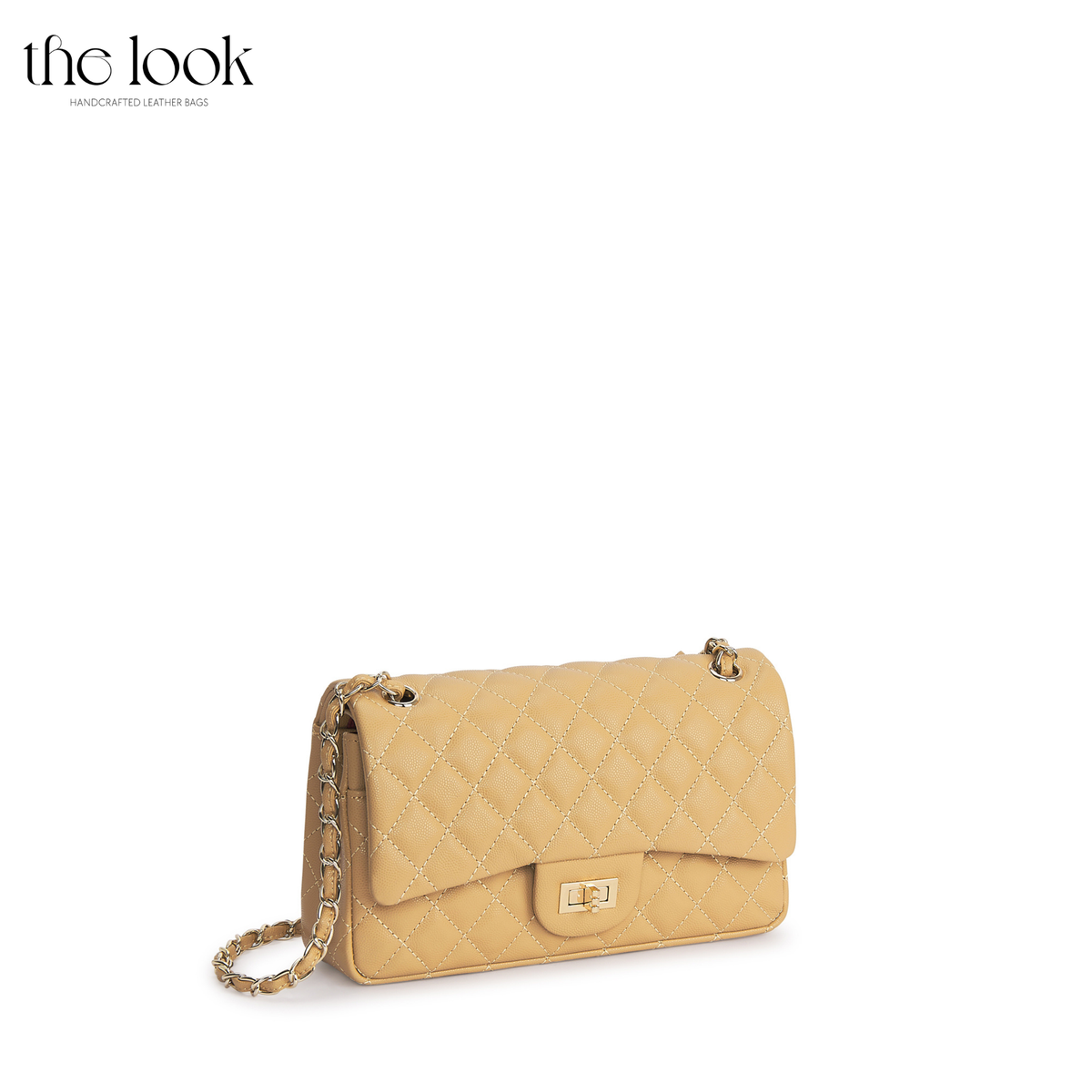 The Quilte Medium Convertible Shoulder Bag in biscuit caviar calfskin leather with silver hardware, angled front view | The Look Officiel