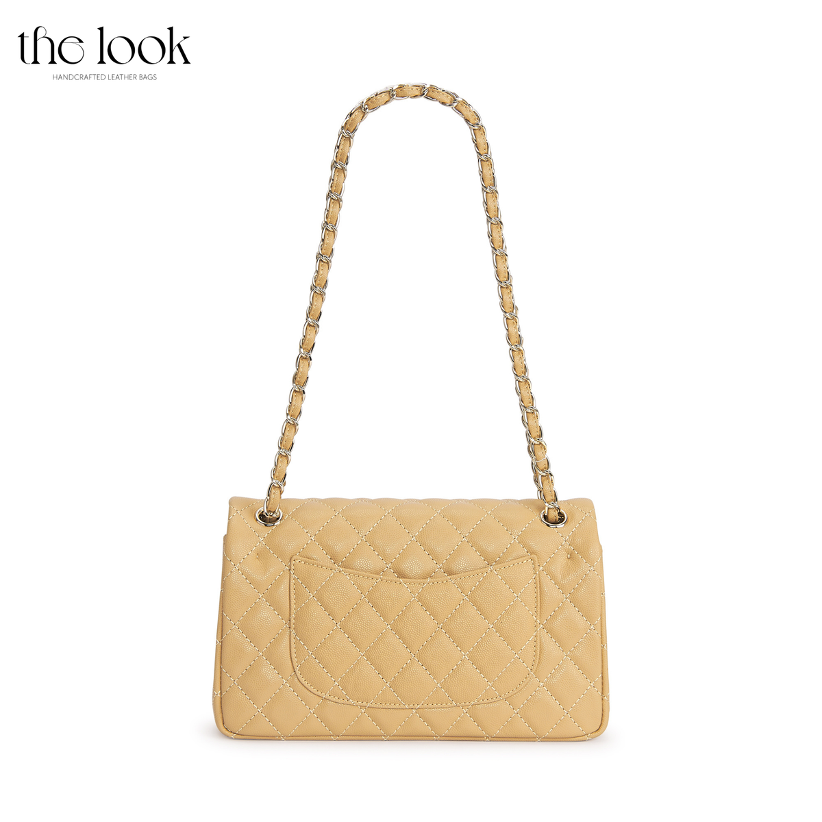 The Quilte Medium Convertible Shoulder Bag in biscuit caviar calfskin leather with silver hardware, back view with chain strap and exterior slip pocket | The Look Officiel