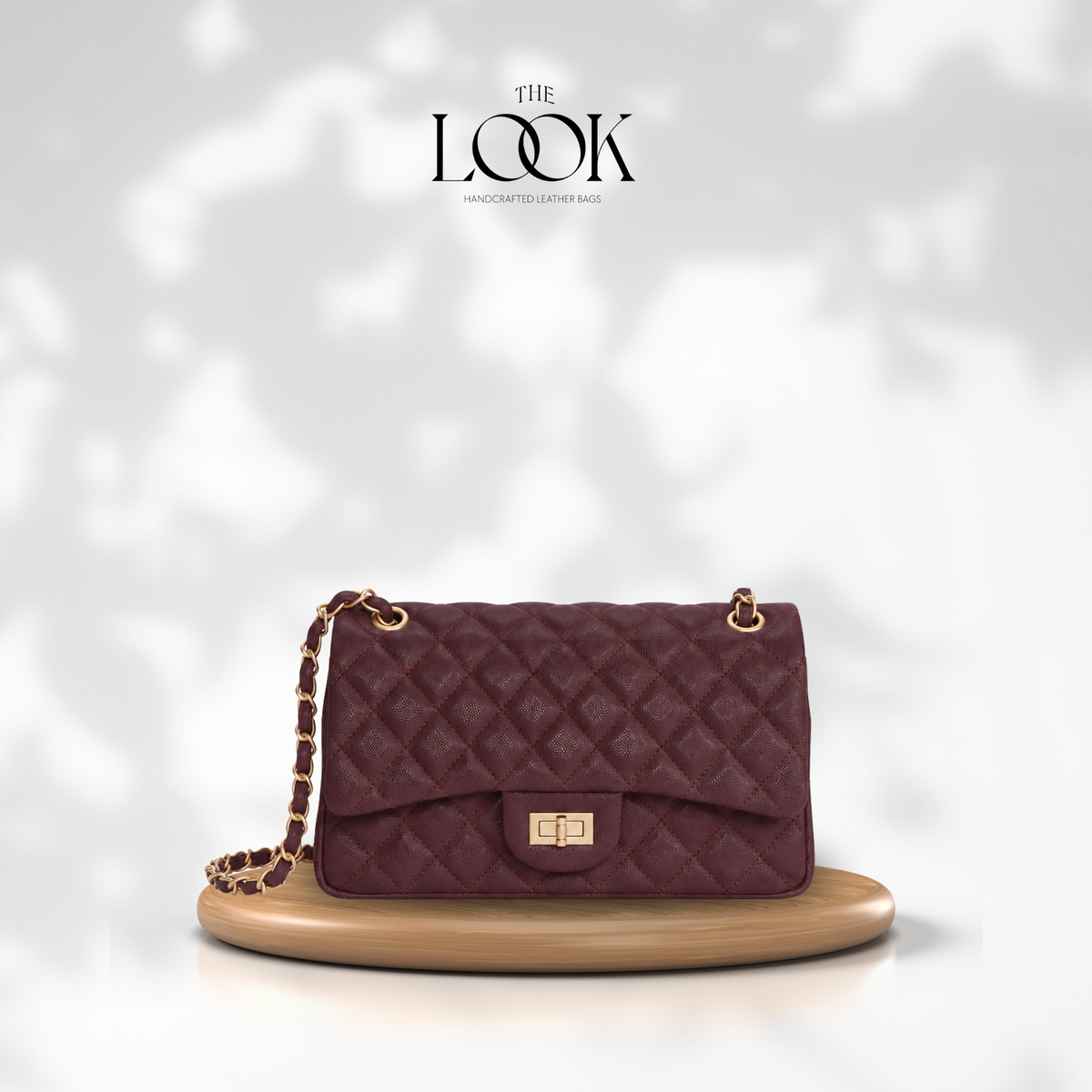The Quilte Medium Convertible Shoulder Bag in Burgundy, caviar calfskin leather with champagne gold hardware, front view | The Look Officiel