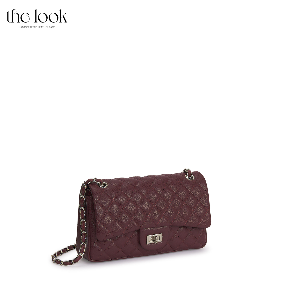 The Quilte Medium Convertible Shoulder Bag in burgundy caviar calfskin leather with silver hardware, angled front view | The Look Officiel