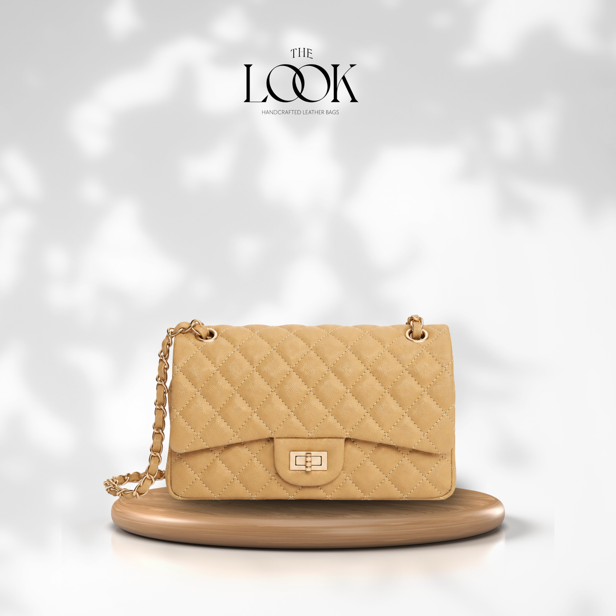 The Quilte Medium Convertible Shoulder Bag in Biscuit, caviar calfskin leather with champagne gold hardware, front view | The Look Officiel