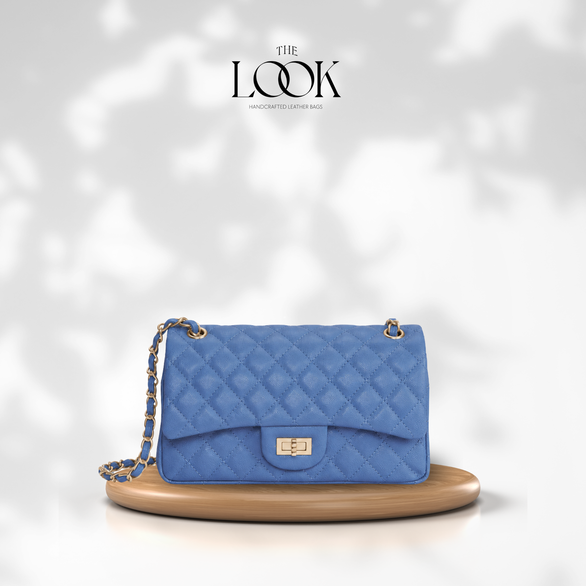 The Quilte Medium Convertible Shoulder Bag in Cornflower Blue, caviar calfskin leather with champagne gold hardware, front view | The Look Officiel