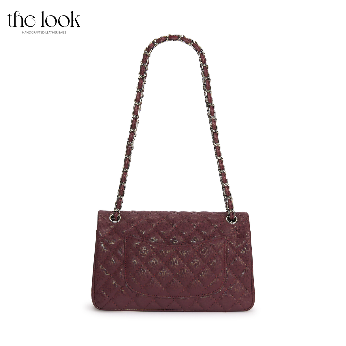 The Quilte Medium Convertible Shoulder Bag in burgundy caviar calfskin leather with silver hardware, back view with chain strap and exterior slip pocket | The Look Officiel