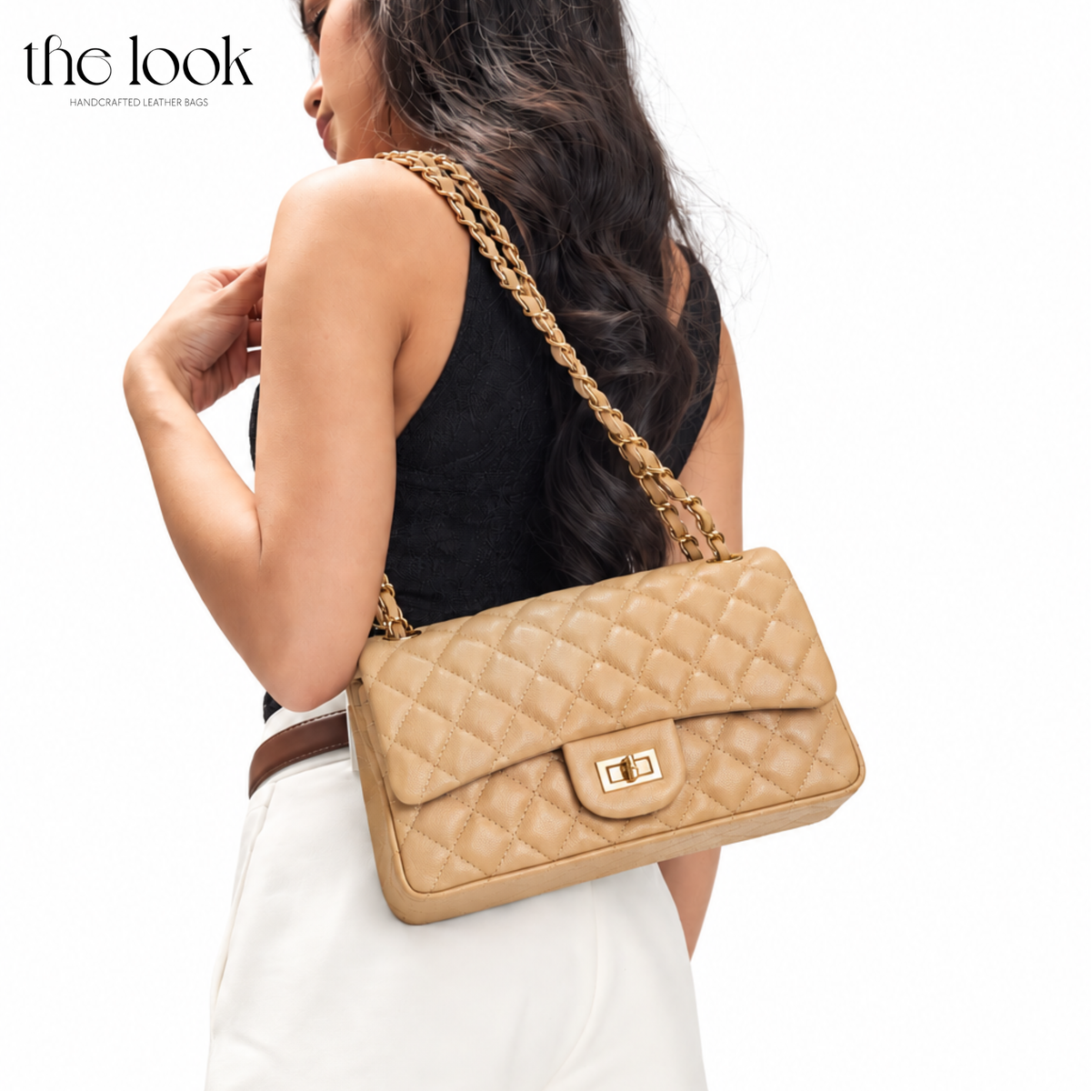 Model carrying The Quilte Medium Convertible Shoulder Bag in Biscuit with quilted leather and champagne gold hardware | The Look Officiel