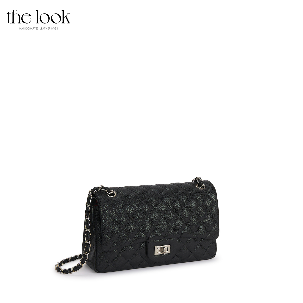 The Quilte Medium Convertible Shoulder Bag in black caviar calfskin leather with silver hardware, angled front view | The Look Officiel