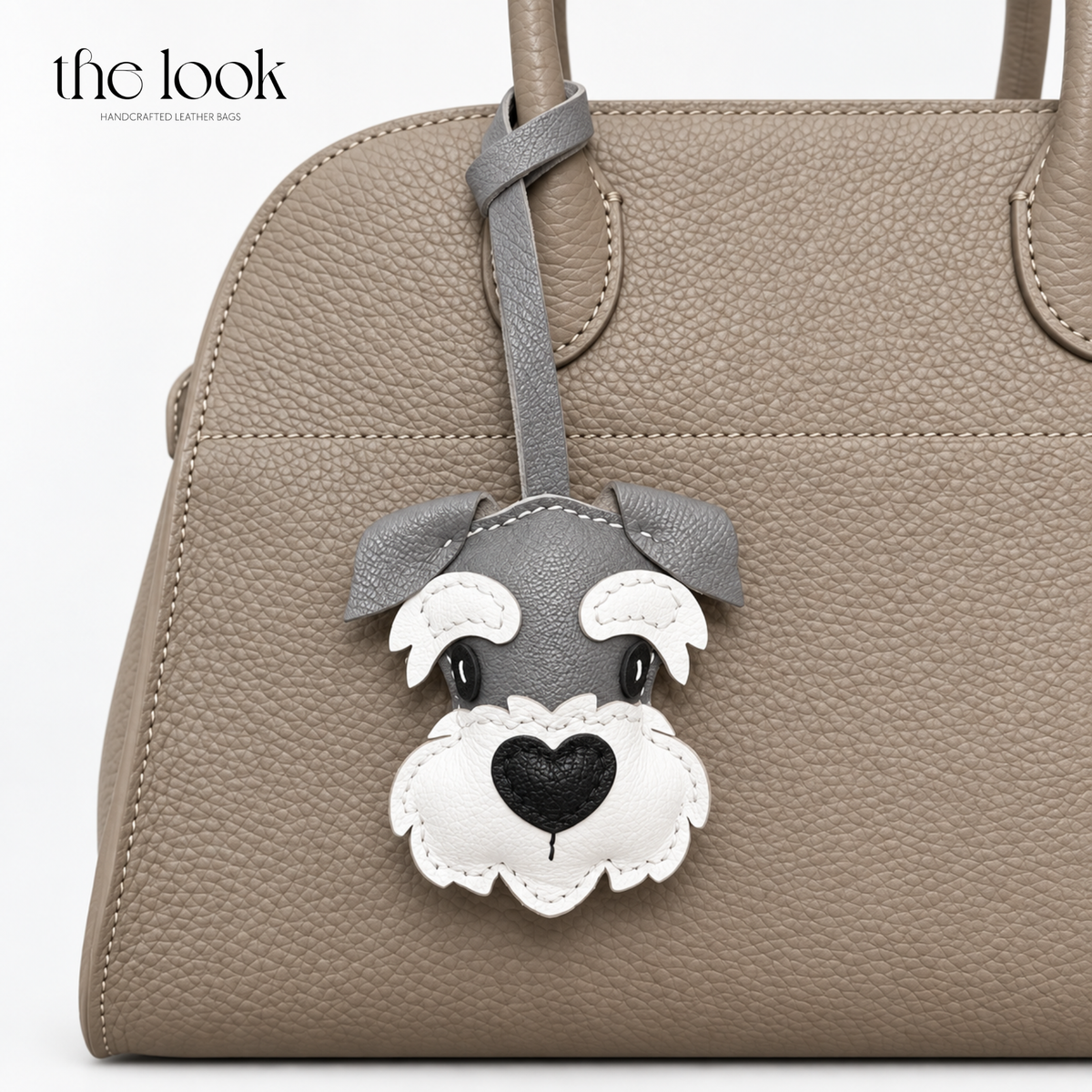 Alfie the Schnauzer grey and white dog bag charm styled on a taupe handbag | The Look Officiel