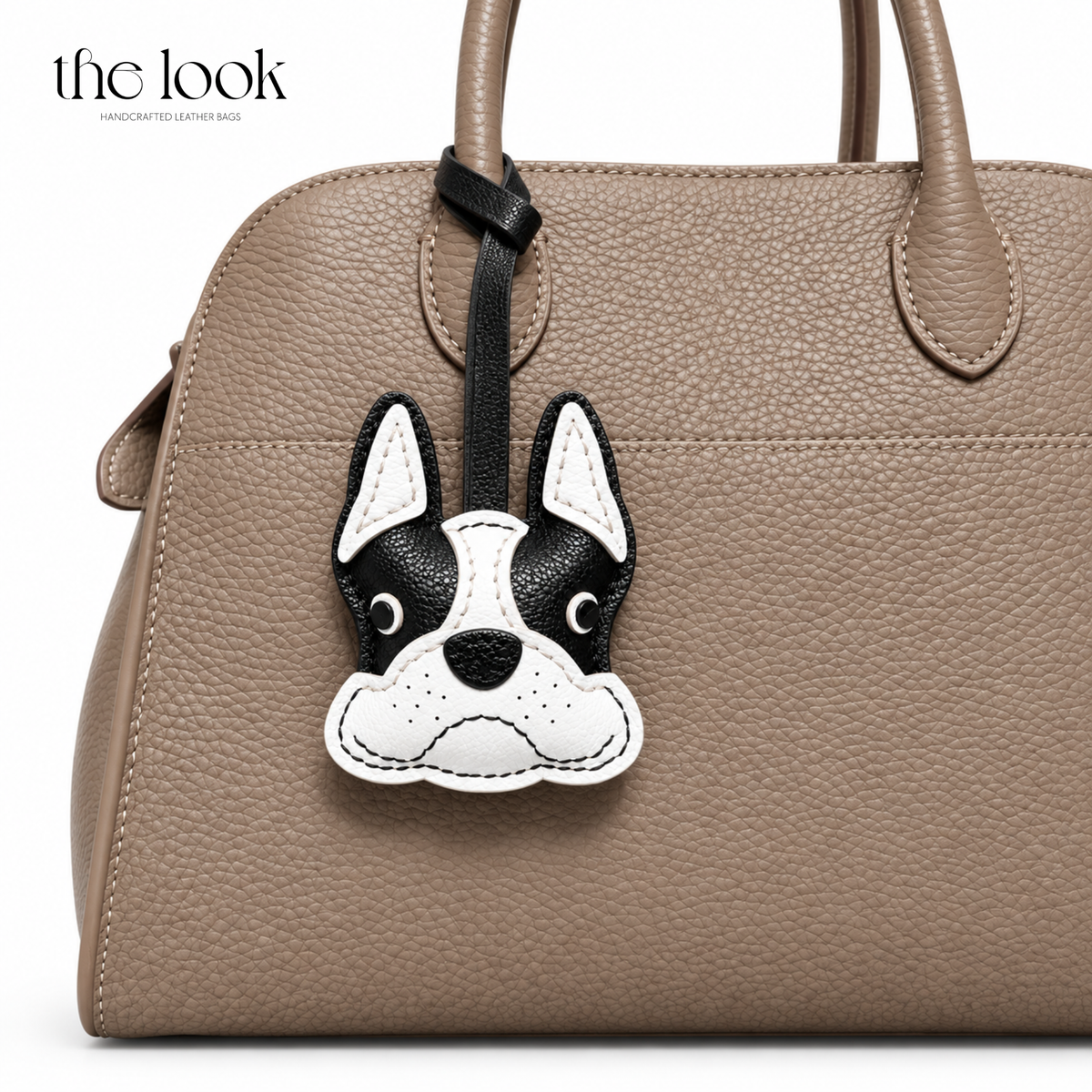 Manny the Frenchie black and white dog bag charm styled on a taupe handbag | The Look Officiel