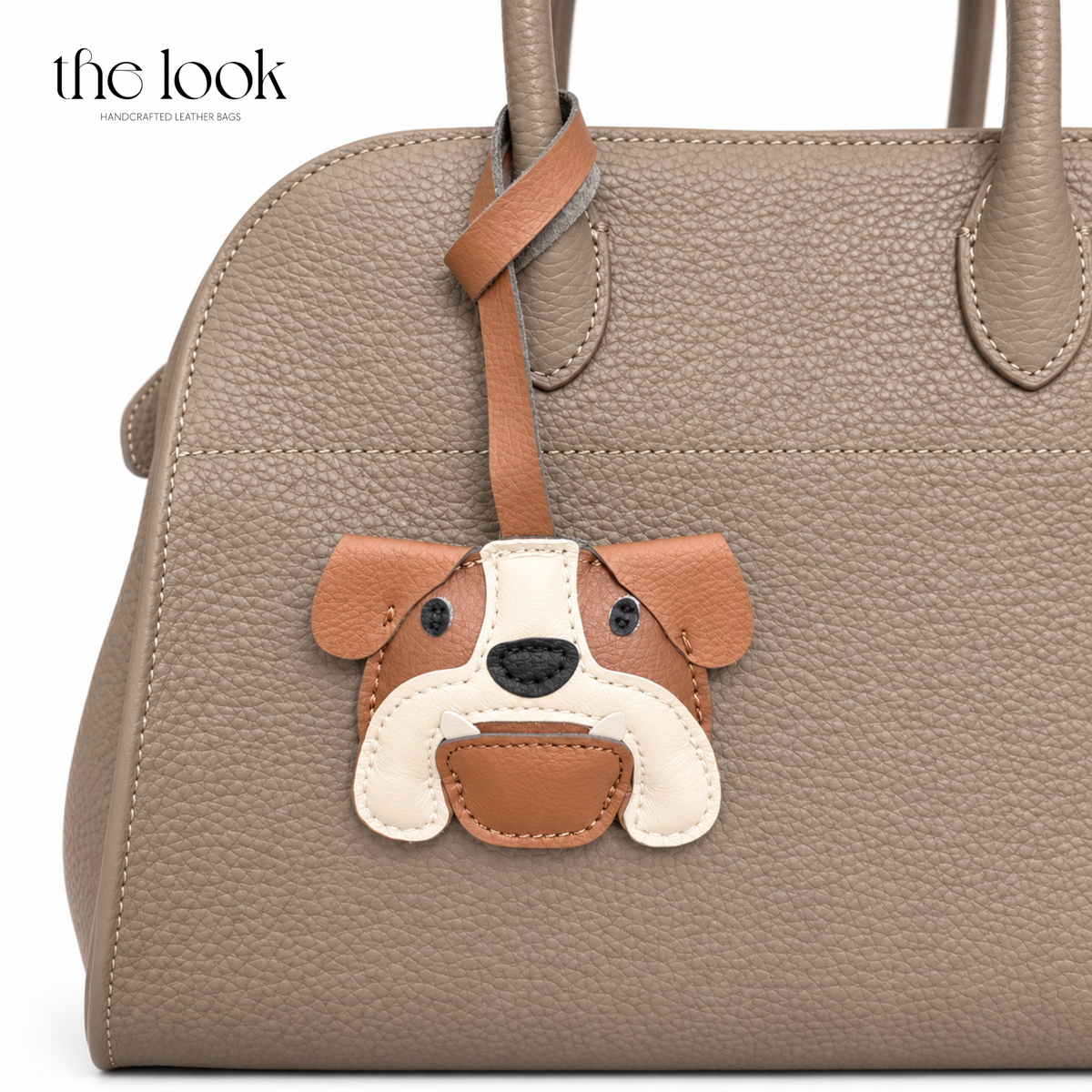 Bruno the Bulldog brown and cream dog bag charm styled on a taupe handbag | The Look Officiel