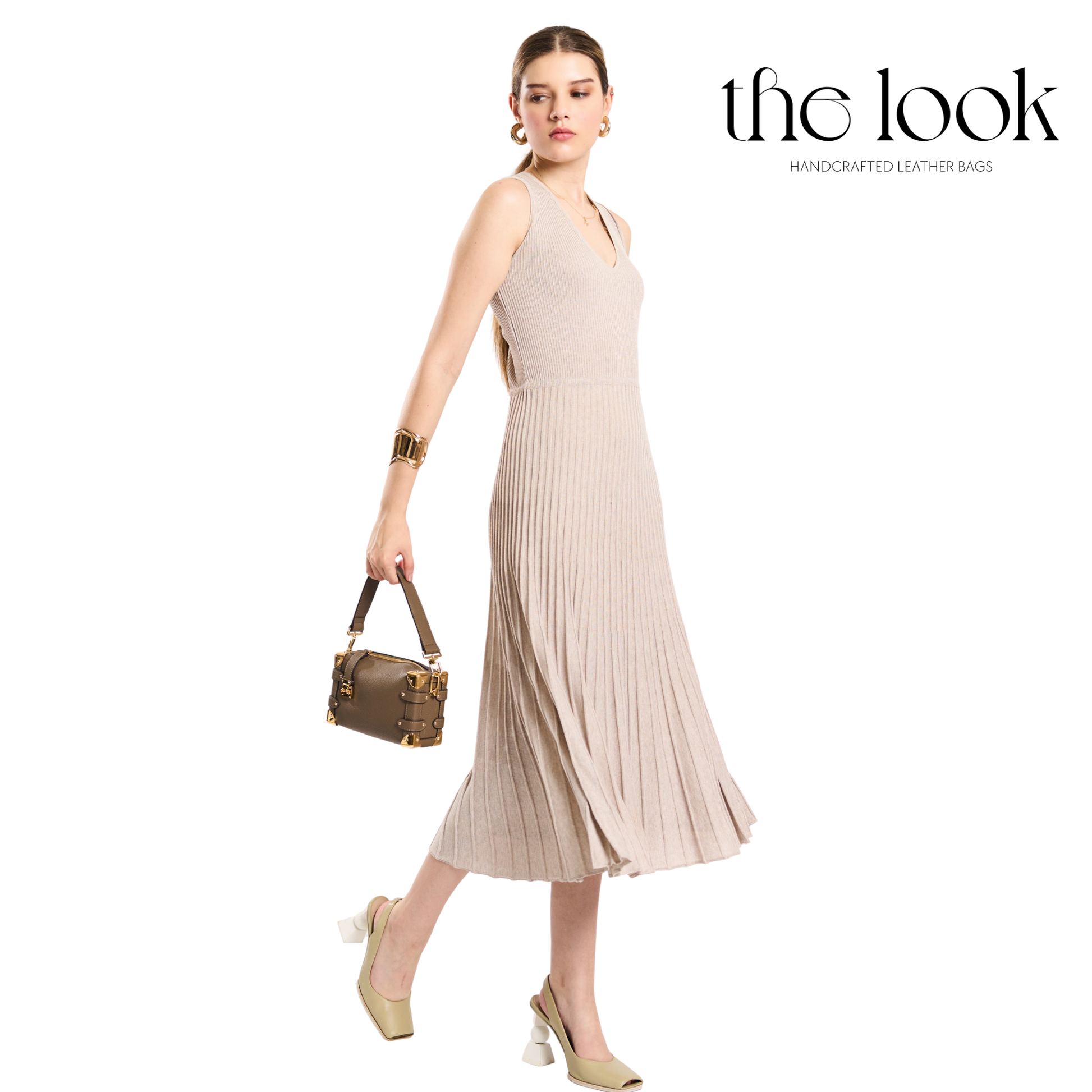 Woman in a beige dress holding a handbag with 'the look' brand on a white background. | The Look Officiel