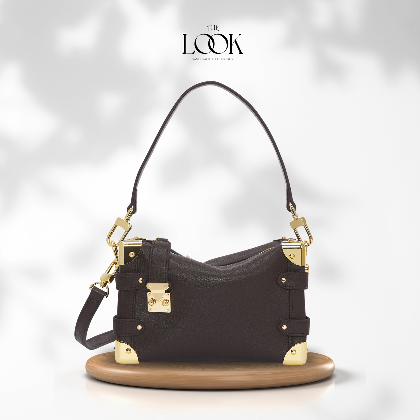 Brown handbag with gold accents on a white background, featuring 'The Look' brand. | The Look Officiel