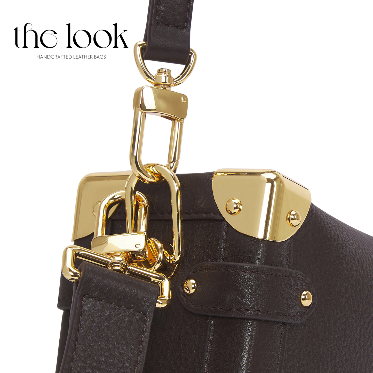 Black leather handbag with gold hardware on a white background, featuring 'the look' brand. | The Look Officiel