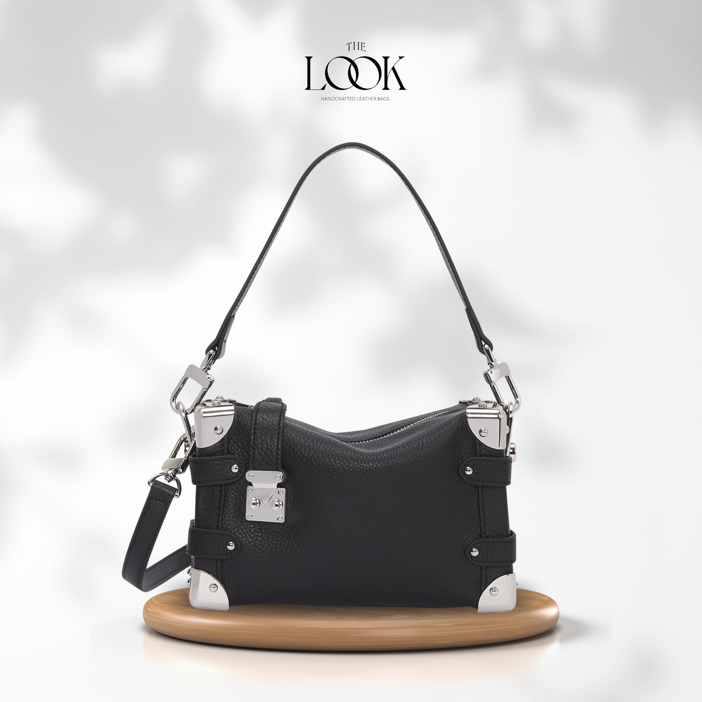 Black handbag with silver hardware on a white background, featuring 'The Look' brand. | The Look Officiel