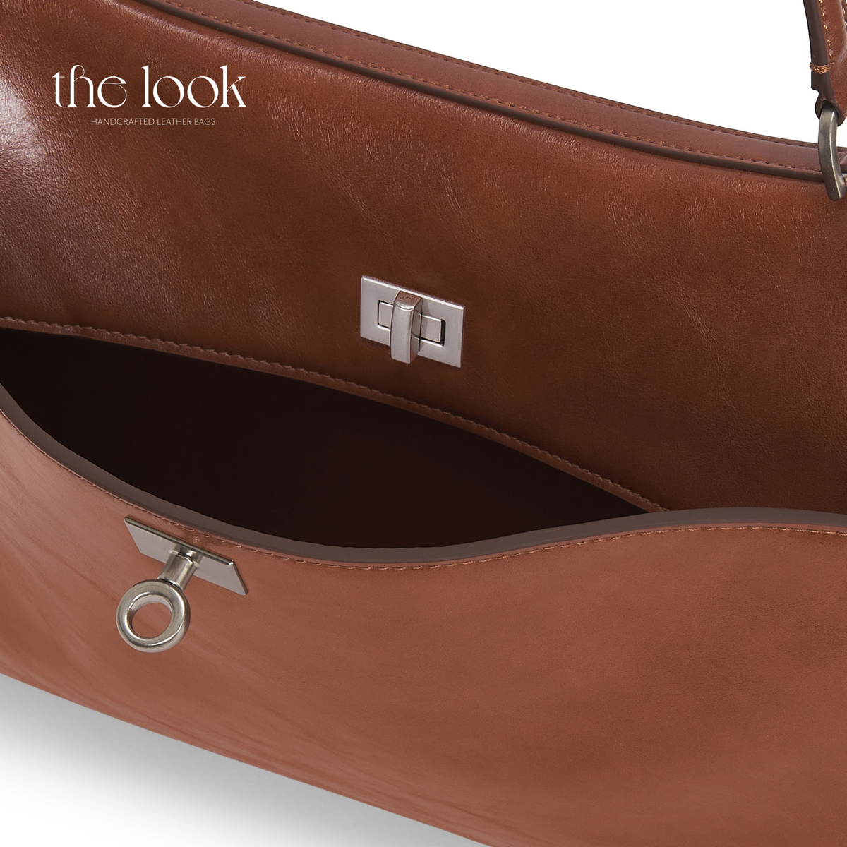 Valen Jumbo Satchel in Caramel, close-up of front closure, stitching and silver-tone hardware | The Look Officiel