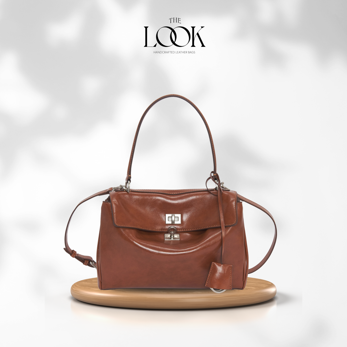 Valen Medium Satchel in Caramel, front product view on wooden platform | The Look Officiel
