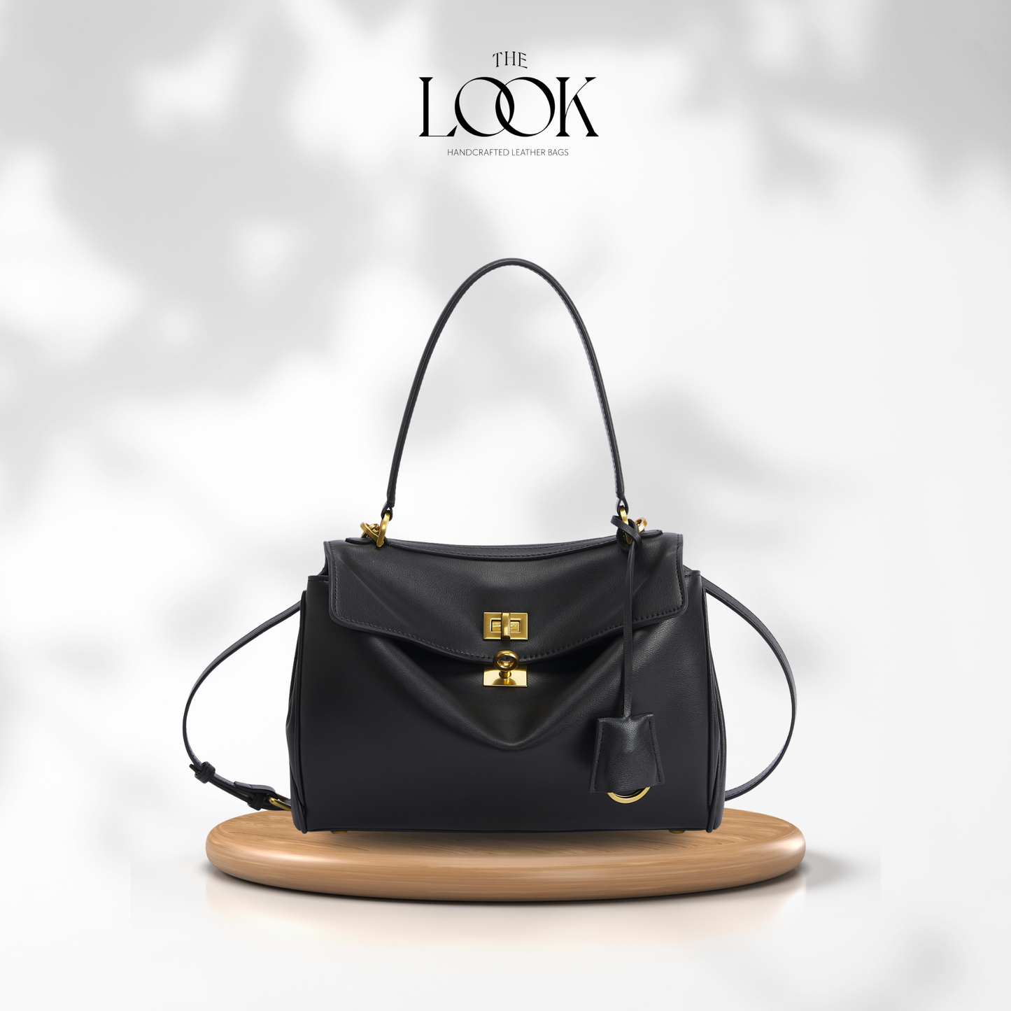 The Valen Medium Satchel — genuine leather handbag, third colour held | The Look Officiel