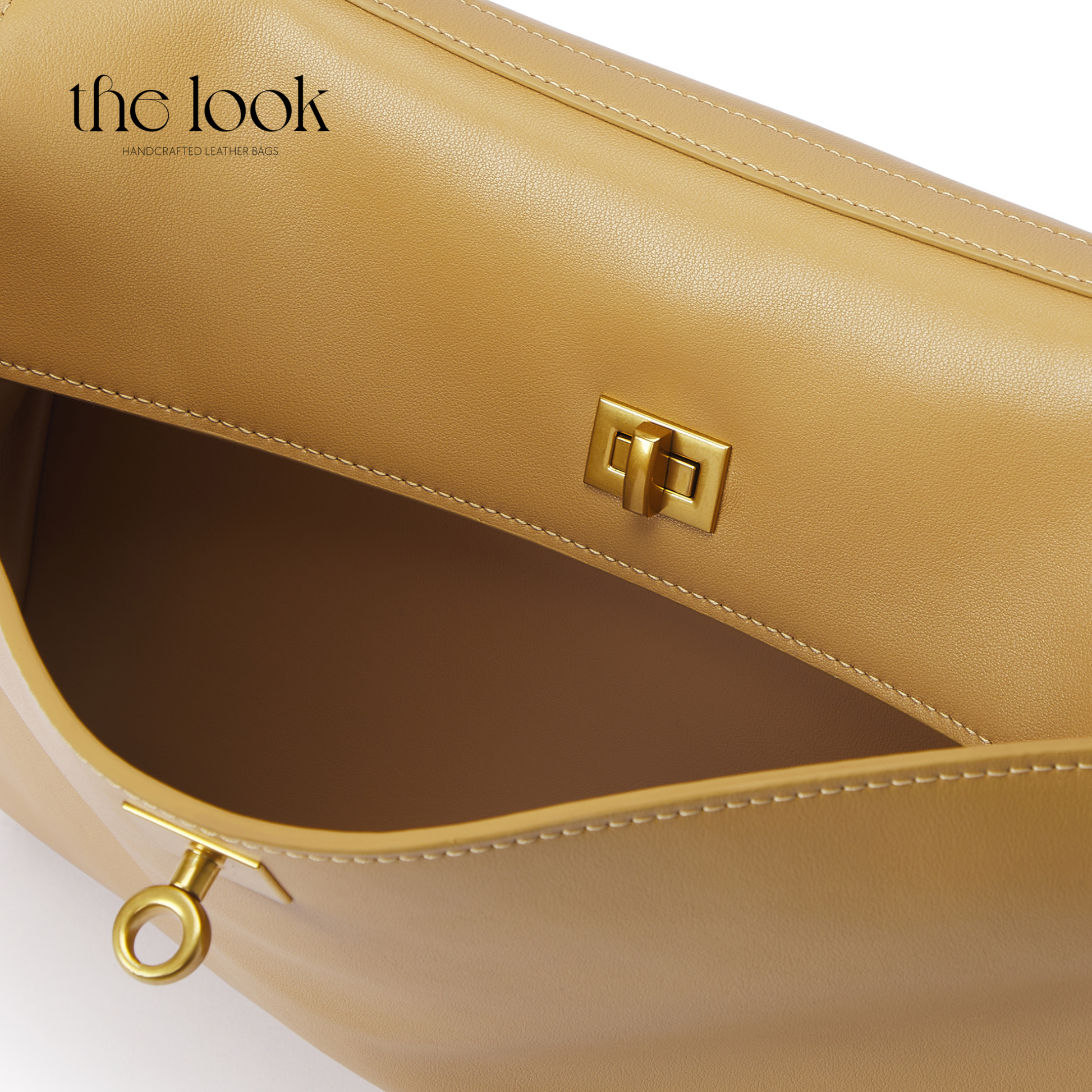 Beige handbag with gold accents on a white background