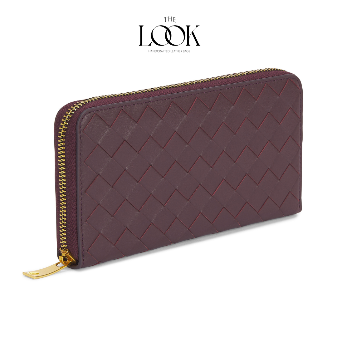 Burgundy lambskin zip-around long wallet with woven pattern and gold-tone hardware angled view