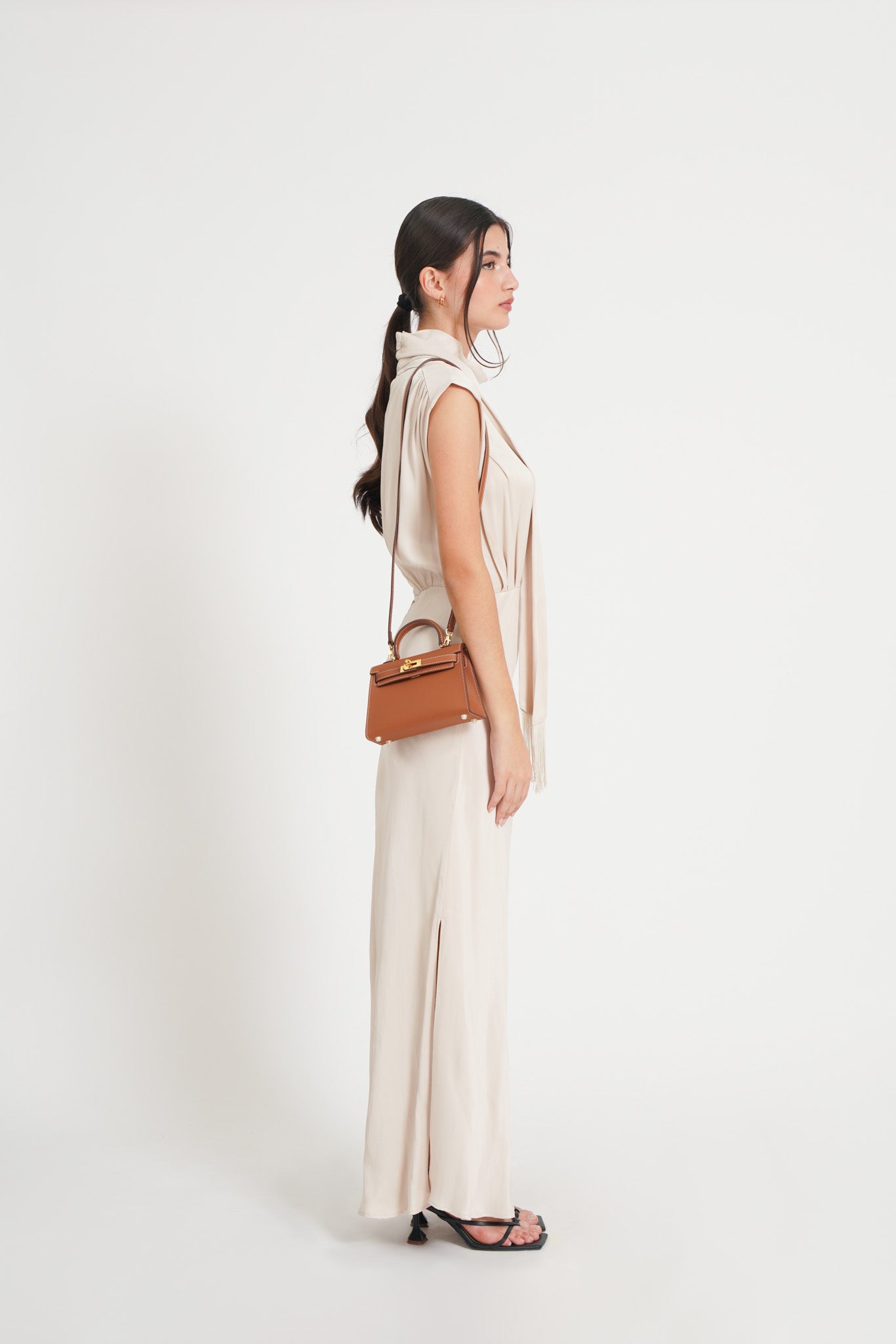 Interior detail of the minimalist black handbag, showcasing silver hardware and high-quality leather finish.